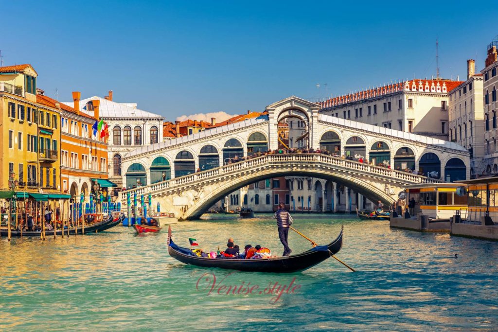 Venice gondola in front of the Rialto bridge of the Grand Canal in Venice